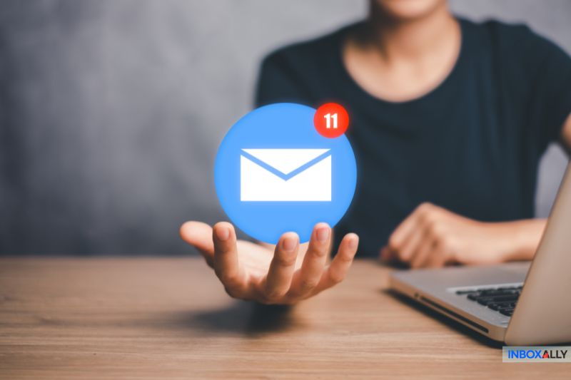 A person holding an email notification icon, symbolising the challenge of resolving "my emails are bouncing" issues effectively.