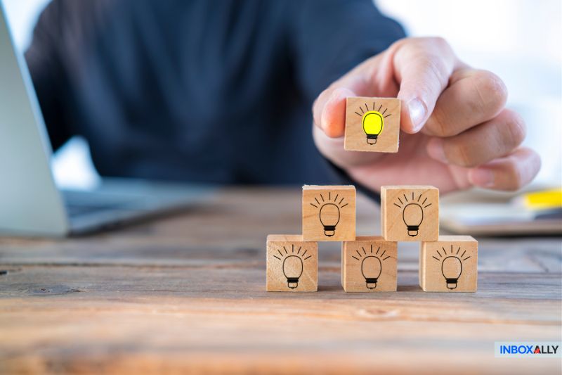 Stacked wooden blocks with lightbulbs, symbolizing troubleshooting SPF failure and finding solutions for email authentication issues