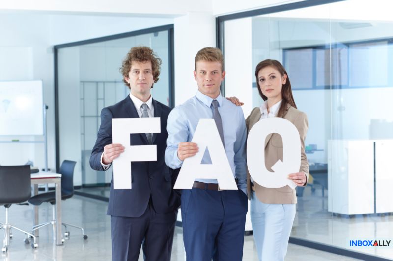 Business professionals holding "FAQ" letters, representing common questions and solutions for SPF failure in email authentication issues