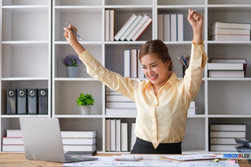 Excited professional celebrates successfully fixing the 550 high probability of spam error and improving email deliverability for better inbox placement.