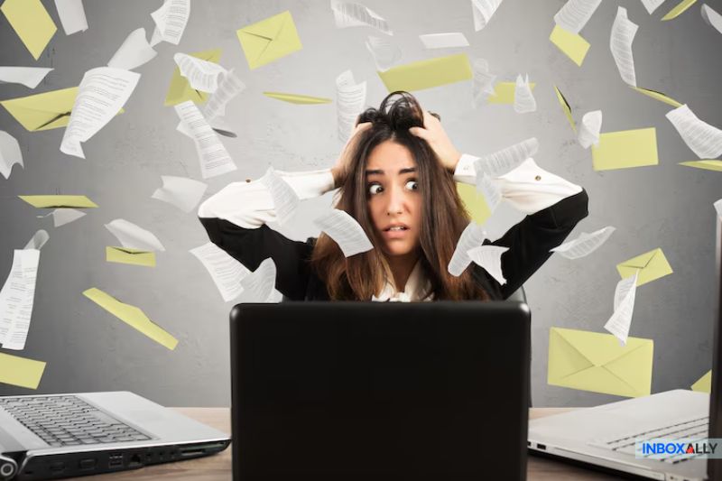 Frustrated woman overwhelmed by emails, symbolizing issues with Google Workspace emails going to spam