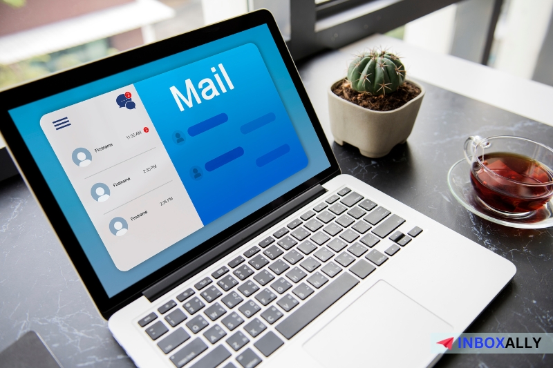 A laptop on a desk showcases an email interface, hinting at Gmail recipient limits. 