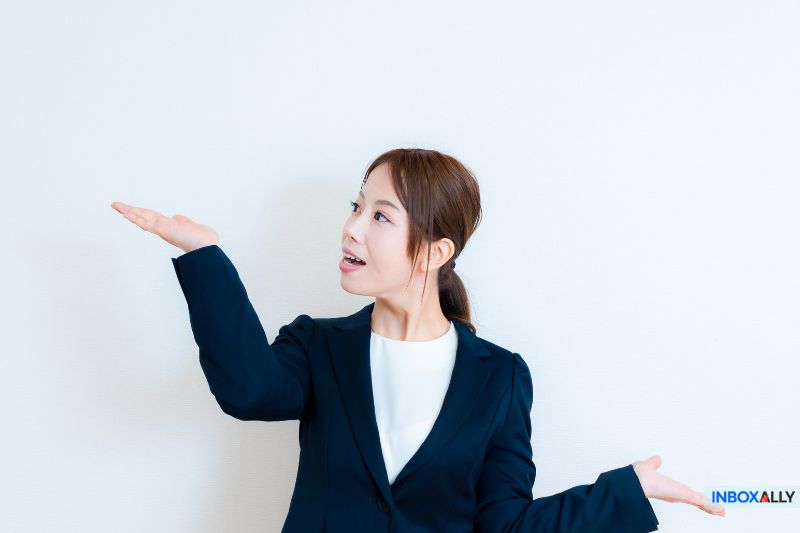 A professional in a suit gestures, symbolizing reliable email solutions hinting at a powerful MailGenius alternative for superior inbox placement