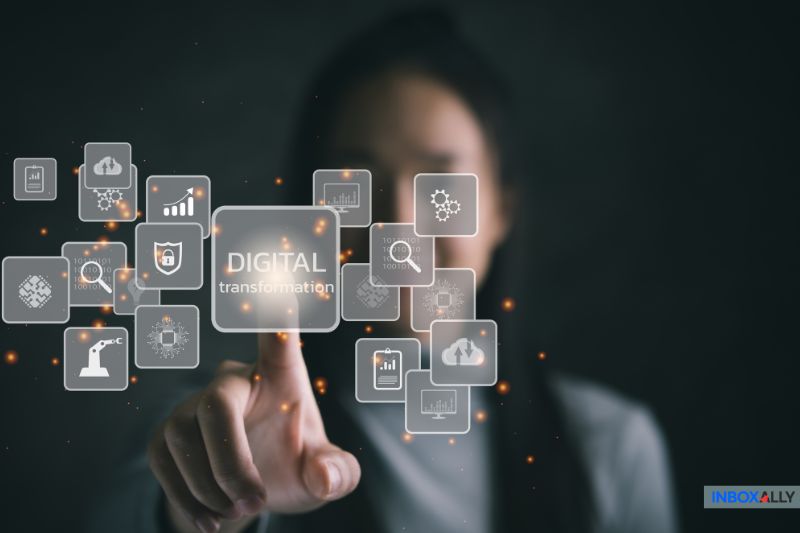 A person is pointing at floating icons related to digital transformation and success, with a blurred background.