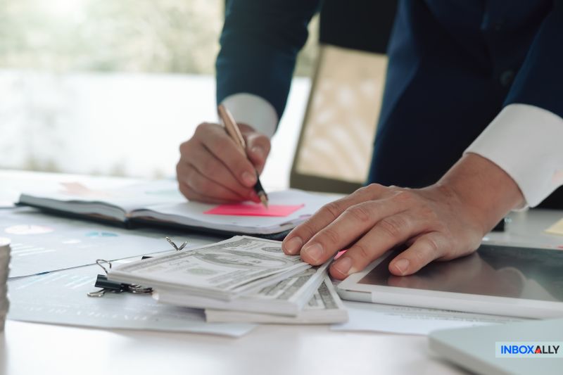 Businessman reviewing finances at a desk, symbolising the search for a reliable Amazon SES alternative in 2025