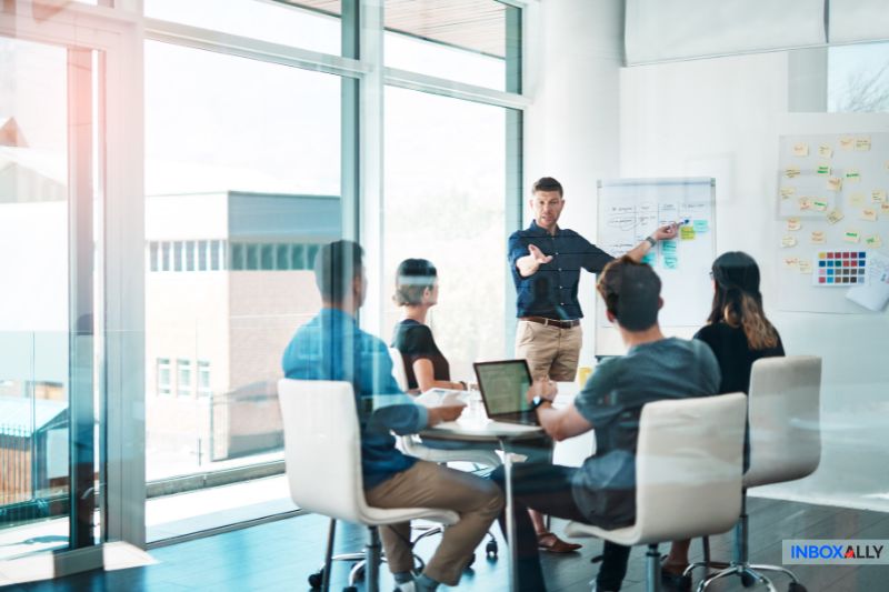 Team brainstorming email throttling strategies in a modern office to improve email deliverability and campaign success rates.