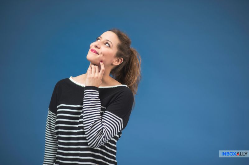 Contemplative woman symbolizing curiosity about email throttling and its role in improving deliverability and managing email flow effectively